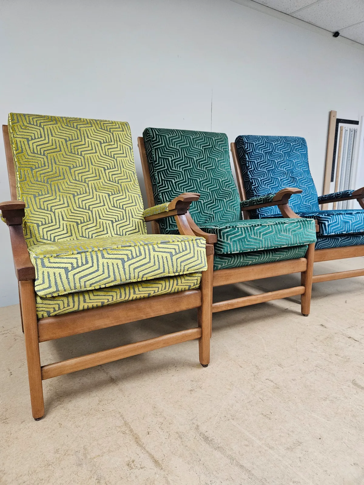 Retro timber armchairs with green and blue patterned cushions
