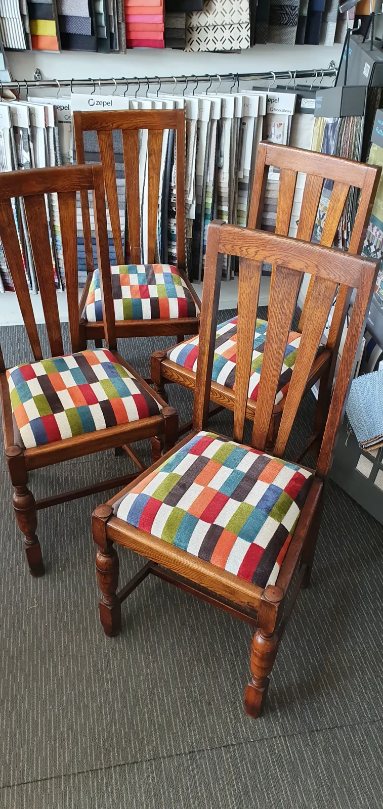 Oak dining chairs reupholstered in multicoloured check fabric