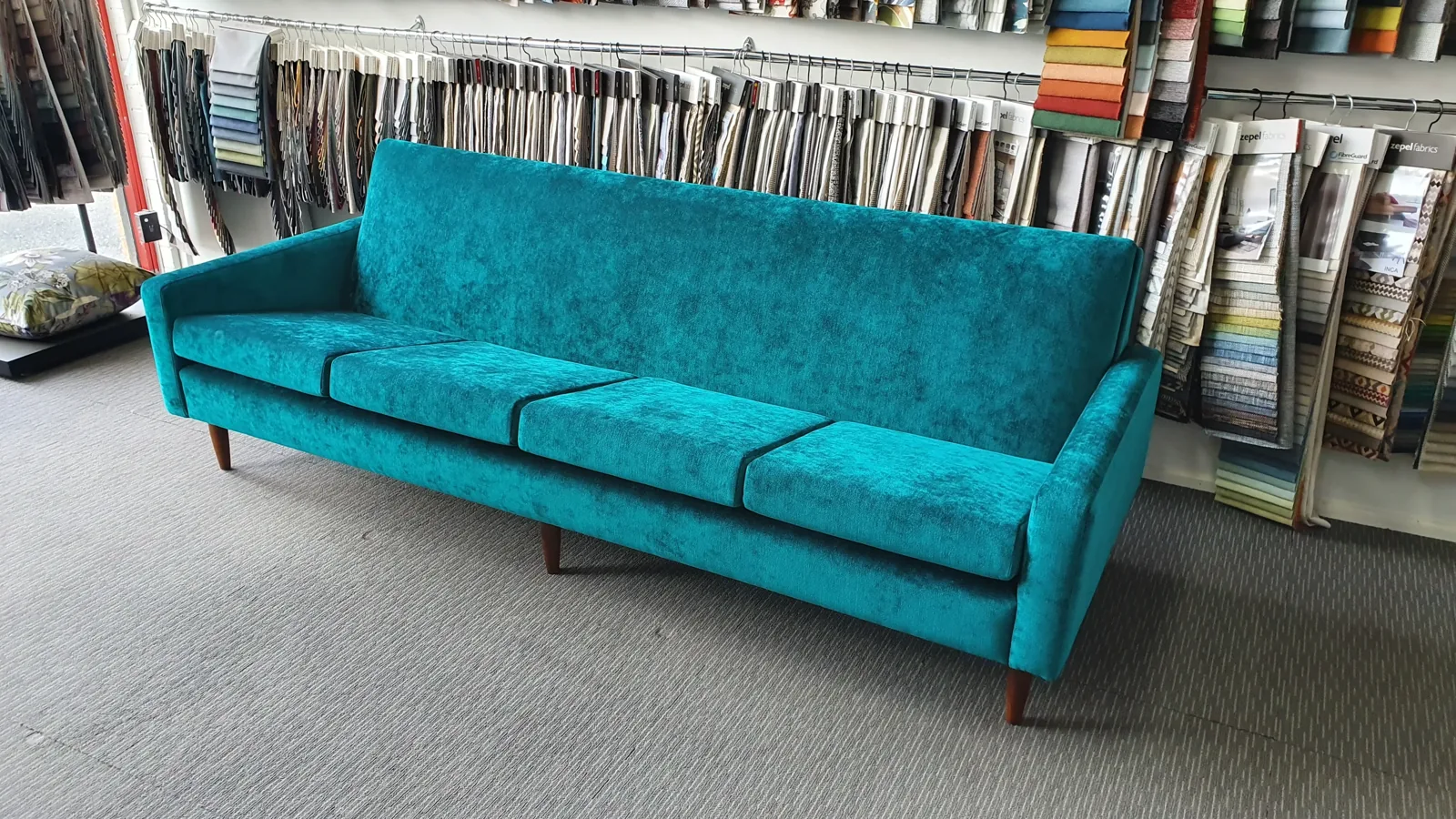 Teal velvet four-seater sofa reupholstered by Signature Upholstery