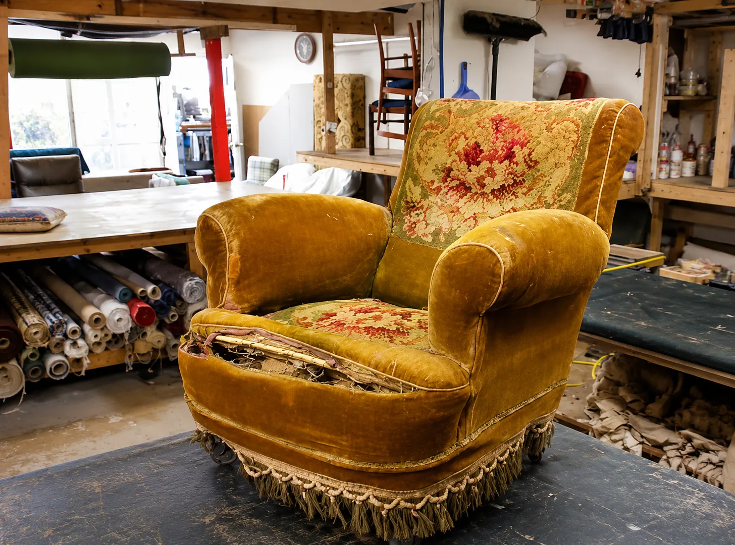Worn orange velvet antique armchair awaiting reupholstery